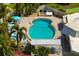 Aerial view of an 8-shaped pool with lounge chairs and lush landscaping at 4440 Ironwood Cir # 509D, Bradenton, FL 34209