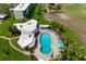 Aerial view of an 8-shaped community pool, landscaping, and building at 4440 Ironwood Cir # 509D, Bradenton, FL 34209