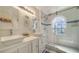 Bright bathroom with double vanity, tiled walk-in shower, and stylish fixtures for a luxurious feel at 446 Burns Ct, Sarasota, FL 34236