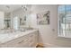 Bathroom with marble countertops, stylish vanity, and a neutral color scheme promotes a relaxing atmosphere at 446 Burns Ct, Sarasota, FL 34236