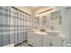 Bright bathroom with double vanity, tiled walk-in shower, and stylish fixtures for a luxurious feel at 446 Burns Ct, Sarasota, FL 34236