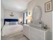 Charming bedroom featuring a comfortable bed, white wicker dresser, and coastal-inspired decor for a relaxing ambiance at 446 Burns Ct, Sarasota, FL 34236