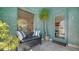 Inviting entryway with decorative blue tile, stylish bench, and ample natural light at 446 Burns Ct, Sarasota, FL 34236