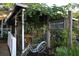 Charming covered patio with rustic decor and a vintage bicycle parked outside at 446 Burns Ct, Sarasota, FL 34236