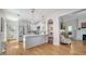 Modern kitchen with white cabinetry, stainless appliances, and an open layout to living area at 446 Burns Ct, Sarasota, FL 34236