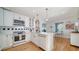 Well-appointed kitchen with quartz countertops, stainless steel appliances, and an adjoining breakfast nook at 446 Burns Ct, Sarasota, FL 34236