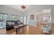 Bright living room with hardwood floors, a comfortable sofa and a view into adjacent dining area at 446 Burns Ct, Sarasota, FL 34236