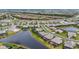 Overhead view of a community with a series of lakes and ponds, surrounded by green spaces and residential houses at 4820 Coastal Days Ln, Bradenton, FL 34211