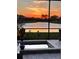 Relaxing backyard view with a spa, lush greenery, and a serene lake at sunset at 4820 Coastal Days Ln, Bradenton, FL 34211