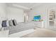Bright bedroom features a padded headboard, stylish pillows, and a flat-screen TV for relaxation at 4820 Coastal Days Ln, Bradenton, FL 34211