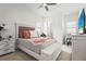 Bedroom features a comfortable bed, side table, and TV with tropical scene, creating a relaxing space at 4820 Coastal Days Ln, Bradenton, FL 34211