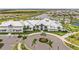 Beautiful clubhouse featuring a circular driveway, manicured landscaping, and ample parking at 4820 Coastal Days Ln, Bradenton, FL 34211