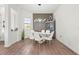 Dining room showcasing a glass table, modern decor, and a unique accent wall at 4820 Coastal Days Ln, Bradenton, FL 34211