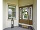 Stylish front door with glass panels, decorative wreath, lantern, and a 'welcome' doormat on tiled entryway at 4820 Coastal Days Ln, Bradenton, FL 34211