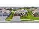 Beautiful single-Gathering home with lush green landscaping, a paver driveway, and a tranquil pond view at 4820 Coastal Days Ln, Bradenton, FL 34211