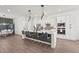 Bright, modern kitchen with a large island, barstool seating, and stainless steel appliances at 4820 Coastal Days Ln, Bradenton, FL 34211