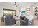 Inviting living room featuring stylish decor, built-in shelving, and large sliding doors to the lanai at 4820 Coastal Days Ln, Bradenton, FL 34211