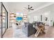 Bright living room with built-in shelves, modern decor, hardwood floors and a glass slider to the outdoor patio at 4820 Coastal Days Ln, Bradenton, FL 34211