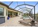 Expansive screened-in patio featuring a pool, lounge chairs and an outdoor dining area with room to spare at 4820 Coastal Days Ln, Bradenton, FL 34211