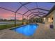 Stunning screened-in pool area with pavers, and a relaxing lounge space to enjoy the sunset and tranquil water views at 4820 Coastal Days Ln, Bradenton, FL 34211