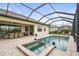 Inviting screened-in pool area with spa, patio furniture, and a well-maintained deck for outdoor enjoyment at 4820 Coastal Days Ln, Bradenton, FL 34211