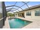 Relaxing pool area with a screened-in enclosure, lounge chairs, and a peaceful view of the surrounding landscape at 4820 Coastal Days Ln, Bradenton, FL 34211