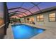 Inviting screened-in pool area with brick pavers and easy access to an outdoor dining area, perfect for relaxation at 4820 Coastal Days Ln, Bradenton, FL 34211