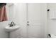 Powder room featuring a stylish pedestal sink, minimalist design, and convenient placement at 4820 Coastal Days Ln, Bradenton, FL 34211