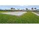 Sand volleyball court surrounded by green grass, offering a great outdoor activity at 4820 Coastal Days Ln, Bradenton, FL 34211