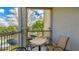 Enjoy fresh air and scenic views from the cozy outdoor balcony space with seating at 5160 Northridge Rd # 206, Sarasota, FL 34238