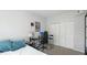Comfortable bedroom with a bed, desk, and closet at 5160 Northridge Rd # 206, Sarasota, FL 34238