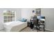 Comfortable bedroom featuring a bed, desk, and window with natural light at 5160 Northridge Rd # 206, Sarasota, FL 34238