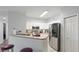 Modern kitchen with stainless steel appliances, white cabinets, and breakfast bar seating at 5160 Northridge Rd # 206, Sarasota, FL 34238