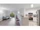 Bright and airy living room, seamlessly connected to modern kitchen and inviting balcony at 5160 Northridge Rd # 206, Sarasota, FL 34238