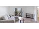 Comfortable living room featuring a stylish sofa and a balcony with outdoor seating at 5160 Northridge Rd # 206, Sarasota, FL 34238