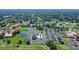 Aerial shot showcasing community tennis courts, pool, parking and lush green landscape at 5630 Golf Pointe Dr # 205, Sarasota, FL 34243