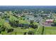 Aerial view of the community highlighting the golf course, tennis courts, pool, and lush green landscape at 5630 Golf Pointe Dr # 205, Sarasota, FL 34243