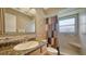 The tiled bathroom has a shower and a granite countertop sink at 5630 Golf Pointe Dr # 205, Sarasota, FL 34243