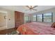 Well-lit bedroom showcasing a bed, window, ceiling fan, and access to a closet at 5630 Golf Pointe Dr # 205, Sarasota, FL 34243