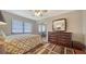 Comfortable bedroom featuring wood dresser, ceiling fan, and sliding door closet at 5630 Golf Pointe Dr # 205, Sarasota, FL 34243