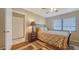 Comfortable bedroom with a ceiling fan, a patterned rug, and a lovely nightstand lamp at 5630 Golf Pointe Dr # 205, Sarasota, FL 34243