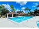 Community pool near pool house, offering a great view and relaxing swimming experience on a sunny day at 5630 Golf Pointe Dr # 205, Sarasota, FL 34243