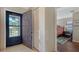 Entryway features a storm door, coat closet, neutral tile, and a view of the bedroom at 5630 Golf Pointe Dr # 205, Sarasota, FL 34243