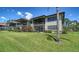 Rear view of a condo featuring private screened patios and views of a pond at 5630 Golf Pointe Dr # 205, Sarasota, FL 34243