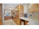Spacious kitchen with wood cabinets, stainless steel appliances, and tiled backsplash at 5630 Golf Pointe Dr # 205, Sarasota, FL 34243