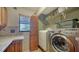 Bright laundry room with side-by-side washer and dryer and convenient folding counter at 5630 Golf Pointe Dr # 205, Sarasota, FL 34243