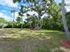 Spacious backyard with a lush green lawn and mature trees at 5910 Majestic Way, Palmetto, FL 34221