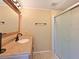 Bathroom with a wood vanity, framed mirror, sink and glass enclosed shower at 5910 Majestic Way, Palmetto, FL 34221