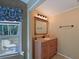 Bathroom with a wood vanity, a granite counter, and a framed mirror at 5910 Majestic Way, Palmetto, FL 34221