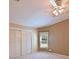 Bedroom with light-colored walls, a ceiling fan, window and a closet with sliding doors at 5910 Majestic Way, Palmetto, FL 34221